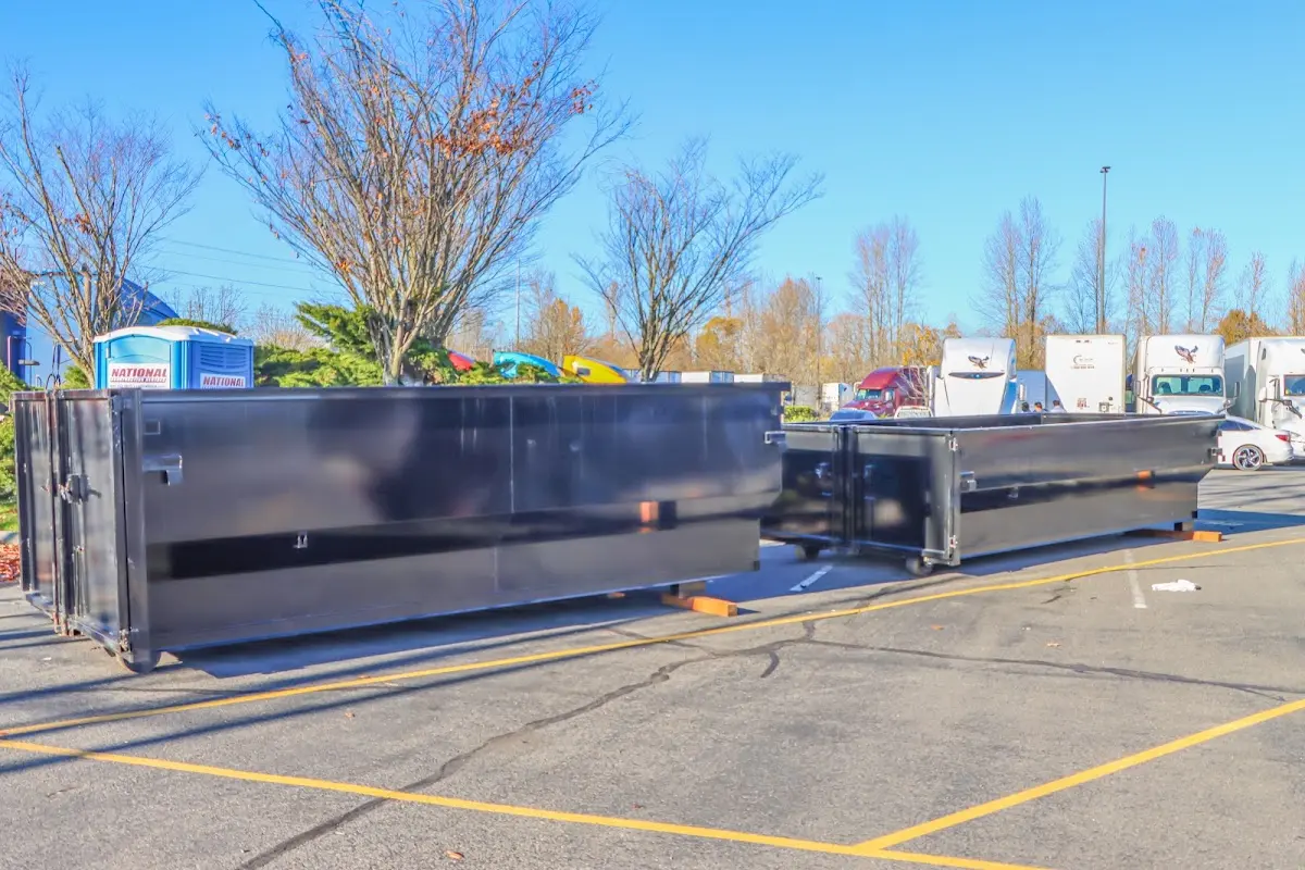 Professional dumpster rental service with roll-off container on residential driveway in Coronado